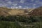 Moroccan village with mountains, river, desert, mountains and lush vegetation