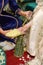 Moroccan wedding. Tradition of the henna night in the Arab Maghreb. A girl trying to dress the bride in traditional Moroccan shoes