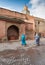 Moroccan women in the Marrakech square, mosque and fountain, copy space