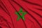 Morocco flag is depicted on a sports cloth fabric with many folds. Sport team banner