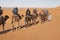 Morocco, Merzouga, Erg Chebbi Dunes, Tourists Riding Camels