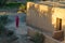 Morocco. Skoura. An old Berber woman in front of her clay house