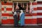 Morocco. Taroudant. Two women in traditional dress in front of a storefront of a butcher\\\'s shop