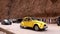 Morocco, Todra - October 2019: Vintage yellow car is driving on mountain road in a dry hot desert on a sunny day