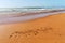 Morocco word is written on the sandy beach of the Atlantic ocean coast in Morocco