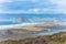 Morro bay. View from Montana de Oro State Park. Cliffs, sandy beach, Morro Rock, mountains and cloudy sky on background, Californi