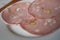 Mortadella slices with pistachios