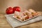mortadella on a white plate with olives. composition with a piece of bread and tomatoes.sausage on a wooden table