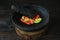 Mortar contains colorful chilies, ready to be pulverized and processed