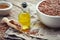 Mortar of flax seeds and bottle of fresh linseed oil.