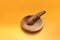 Mortar and pestle isolated on orange background