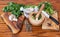 Mortars and spicy herbs on wooden table