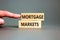 Mortgage markets symbol. Concept words Mortgage markets on beautiful wooden blocks. Beautiful grey table white background.