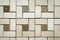 Mosaic of beige and brown marble in the form of squares and rectangles.