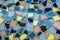 Mosaic of broken tiles on grey background outside. Textured colourful floor