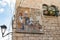 Mosaic describing life in the city in the Middle Ages on the wall of a residential building on Star Street in Bethlehem in the