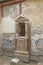 Mosaic lararium in house of the Skeleton in Ancient Ercolano (Herculaneum) city ruins