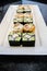 Mosaic sushi roll with cucumber and crab stick served on white plate