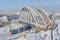 MOSCOW, FEB. 01, 2018: View on Russian railways passenger trains running under new metal bridge under construction. Winter industr