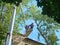 MOSCOW, JUL, 29, 2018: View on workers cutting tops of the trees by chainsaw at elevator crane machine on the building roof altitu