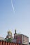 Moscow Kremlin. Blue sky background. Airplane trace.