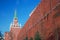 Moscow Kremlin. Color photo. Trinity tower and old wall made of red bricks.