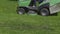 MOSCOW - MAY 24: Worker mows green grass lawnmower on spring day, on May 24, 2017 in Moscow, Russia. FHD stock footage