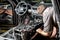 Moscow. November 2018. A mechanic repairs an Audi ... Repairing wiring, gearboxes, disassembled interior premium crossover.