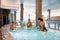Moscow, Russia, 01.02.2019, three mothers with three babies bathe in a jacuzzi, sauna, pool