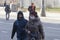 Moscow, Russia: 03.22.2020. Coronavirus pandemic. Woman with face medical protective mask and teenager walk down the street