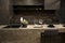 MOSCOW / RUSSIA - 04/03/2019 luxurious spacious modern kitchen island in black grey brown stone marble tones, a sink, a