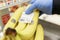 Moscow, Russia, 04/07/2020; Hand in a glove placing a price tag on bananas at a supermarket. Close-up, background in focus