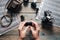 Moscow. Russia - 04 23 2020: top view of woman hands, photographer with analog cameras, film, lenses on old wooden table