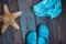 Moscow, Russia - 05.28.2018: baby beach Slippers starfish baby swimming trunks on wooden table