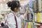 Moscow, Russia, 06/18/2020: a young girl with a backpack selects a book on the shelves in the store. Big choice. Education,