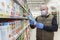 Moscow, Russia, 07/04/2020: A man in a medical mask and gloves chooses juice in a large supermarket. Precautions during the