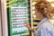 Moscow, Russia, 08/02/2019: Young beautiful woman in McDonald`s chooses food on an electronic board