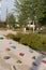 Moscow, Russia - 08.08.2021. Children playground with climbing wall hand holds bulges, trees, metal pergola in the back. Tyufeleva