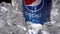 Moscow, Russia - 09 06 2020: Close up sign Pepsi blue metal can iced in crushed ice with droplets of water spin or