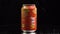 Moscow, Russia - 14 04 2020: Orange metal can with a volume of 0.33 spins on a black background. Mango juice in tin can