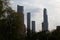 MOSCOW / RUSSIA - 20/04/2019 vertical distant cityscape day view of the tops of the Moscow City skyscrapers hidden behind tall