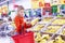 Moscow, Russia, 22/11/2018: A young woman puts in a basket a bunch of bananas in a supermarket