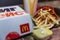 Moscow, Russia, 26/03/2020: Food from McDonald`s on a tray. French fries, hamburger, sauce and drink. Close-up