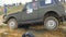 Moscow, Russia 9 June: SUVs race on dirt. Driver competing in an off-road 4x4 competition. An SUV driving through mud