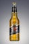 Moscow, Russia - April 07, 2021: Miller genuine draft beer in transparent glass bottle on grey background