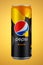 Moscow, Russia - April 07, 2021: Pepsi MANGO in colored aluminum can on orange background. Pepsi is popular refreshing carbonated