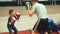 Moscow, Russia - April 12, 2019: Cute boy training with coach and in boxing gym first time. Little boy in boxing gloves
