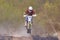 Moscow, Russia - April 13, 2019: Racer on a motocross bike jumps on the springboard. Training of motocross sports team