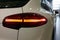 Moscow, Russia - April 22, 2019: Close up of the trunk lid, rear side mirror and taillights of the premium SUV.  White Porsche