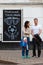 MOSCOW, RUSSIA - APRIL 30, 2018: People near the chalkboard on Solyansky proezd with the advertisement of football broadcasts